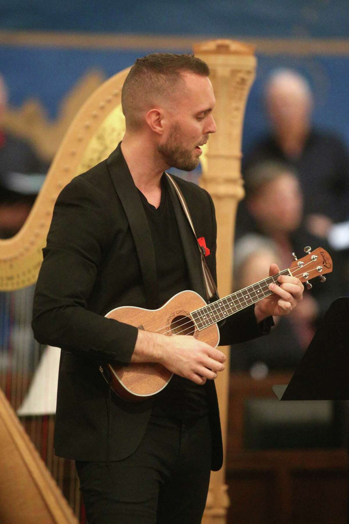Justin Langham plays the ukulele during a Christmas concert at First United Methodist Church on Sunday, Dec. 11, 2022, in Missouri City. He formed an ensemble to play the instrument. It was so successful that the church begged him "please don't let this be the last time."