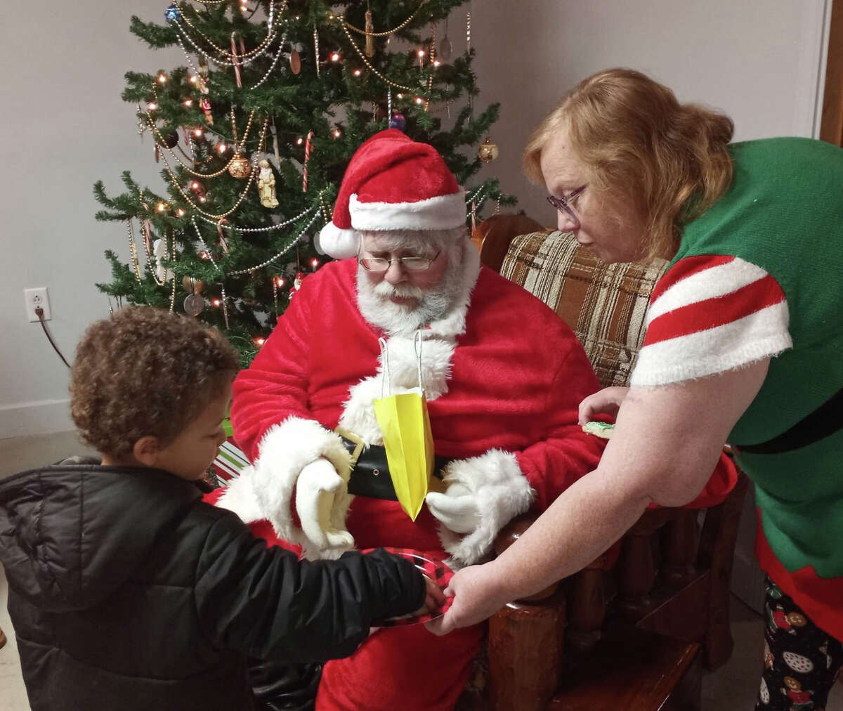 River Community Center in Baldwin hosted a Christmas cookie party for kids Saturday, Dec. 10. Above, children visit Santa Claus. 