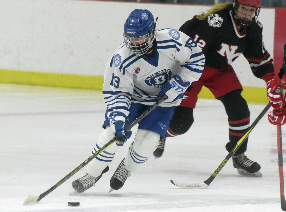 Darien's Chelsea Donovan (19) skates through center ice during a girls ice hockey game against New Canaan at the Darien Ice House on Monday, Jan. 10, 2022.