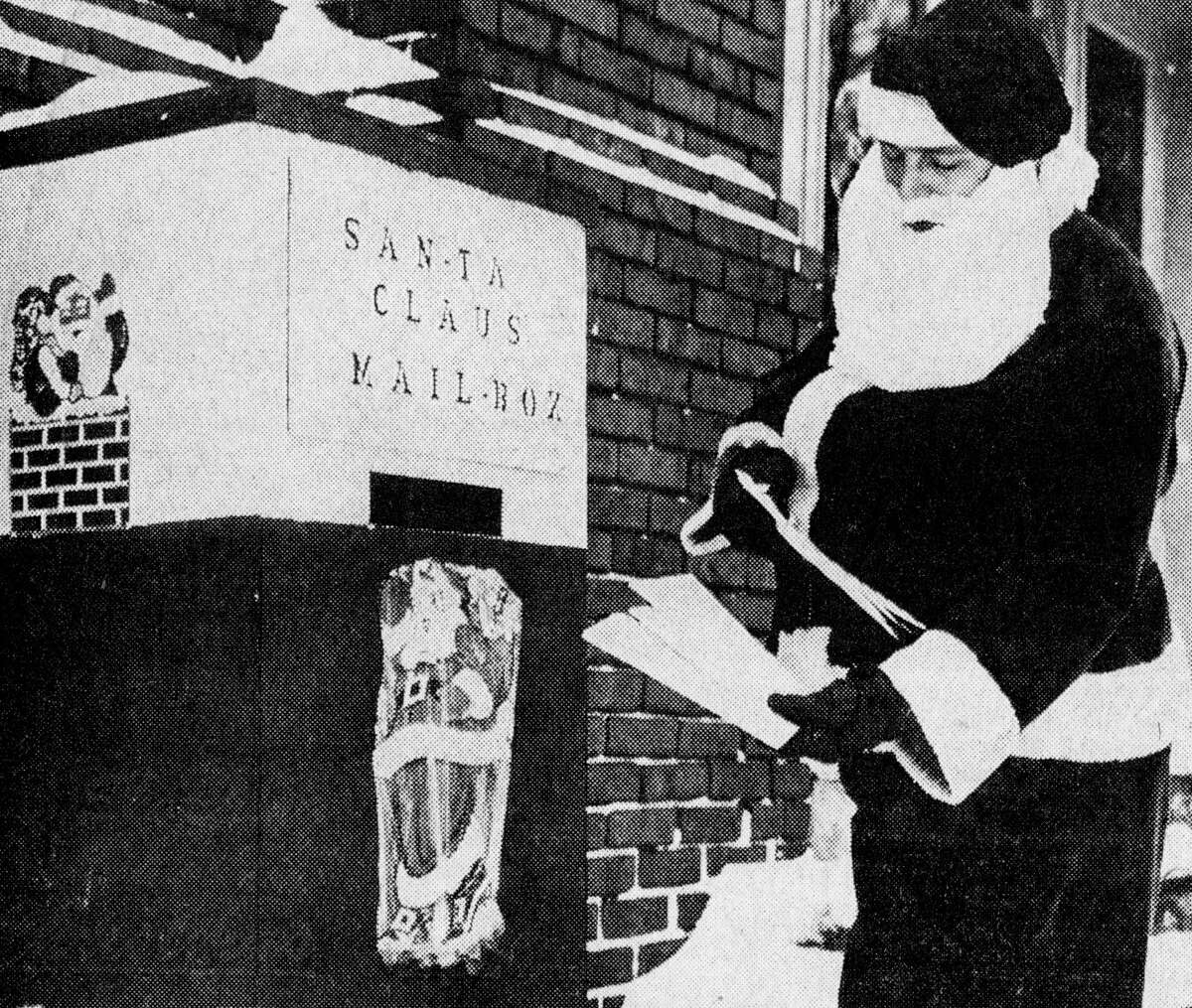 Santa Claus looks at some of the letters deposited in the Manistee Recreation Association Santa Claus mailbox located on Maple Street. Santa Claus will be at the MRA from 10 to 11:30 a.m. and from 1 to 2:30 p.m., on Monday, Wednesday and Friday. The photo was published in the News Advocate on Dec. 14, 1962.