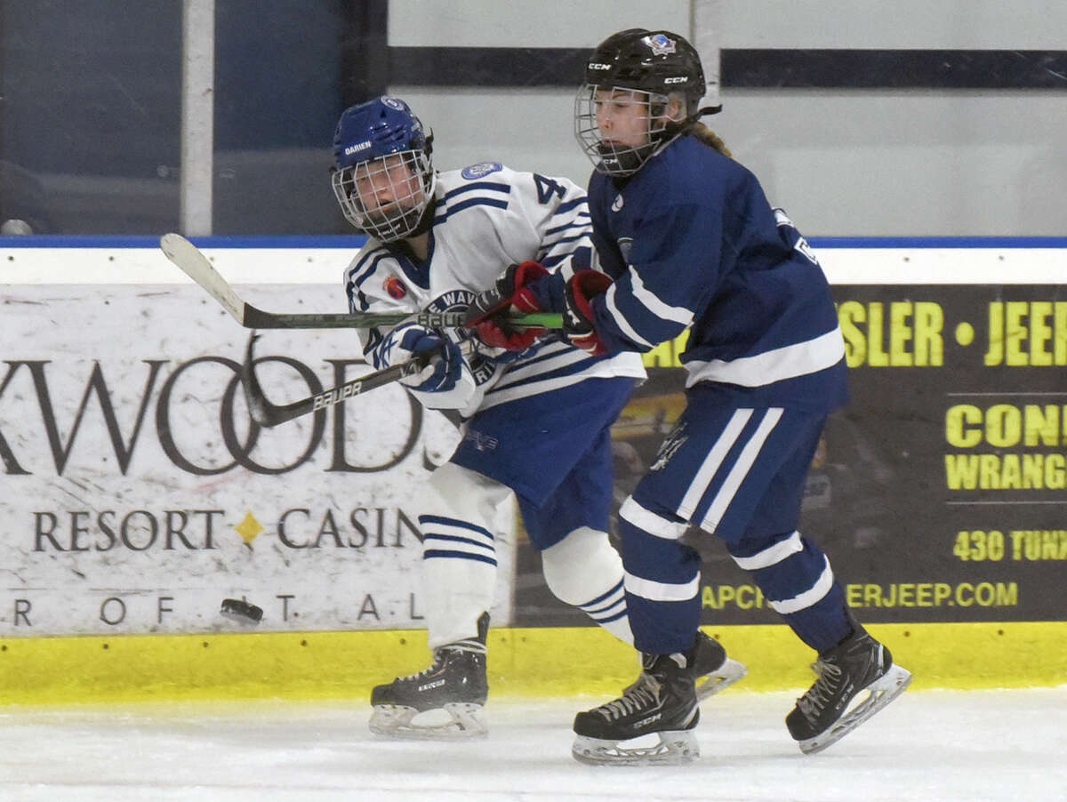 Darien's Keira Austen (4) sends a pass towards the Avon net during the CHSGHA girls ice hockey semifinals in Shelton on Saturday, March 5, 2022.
