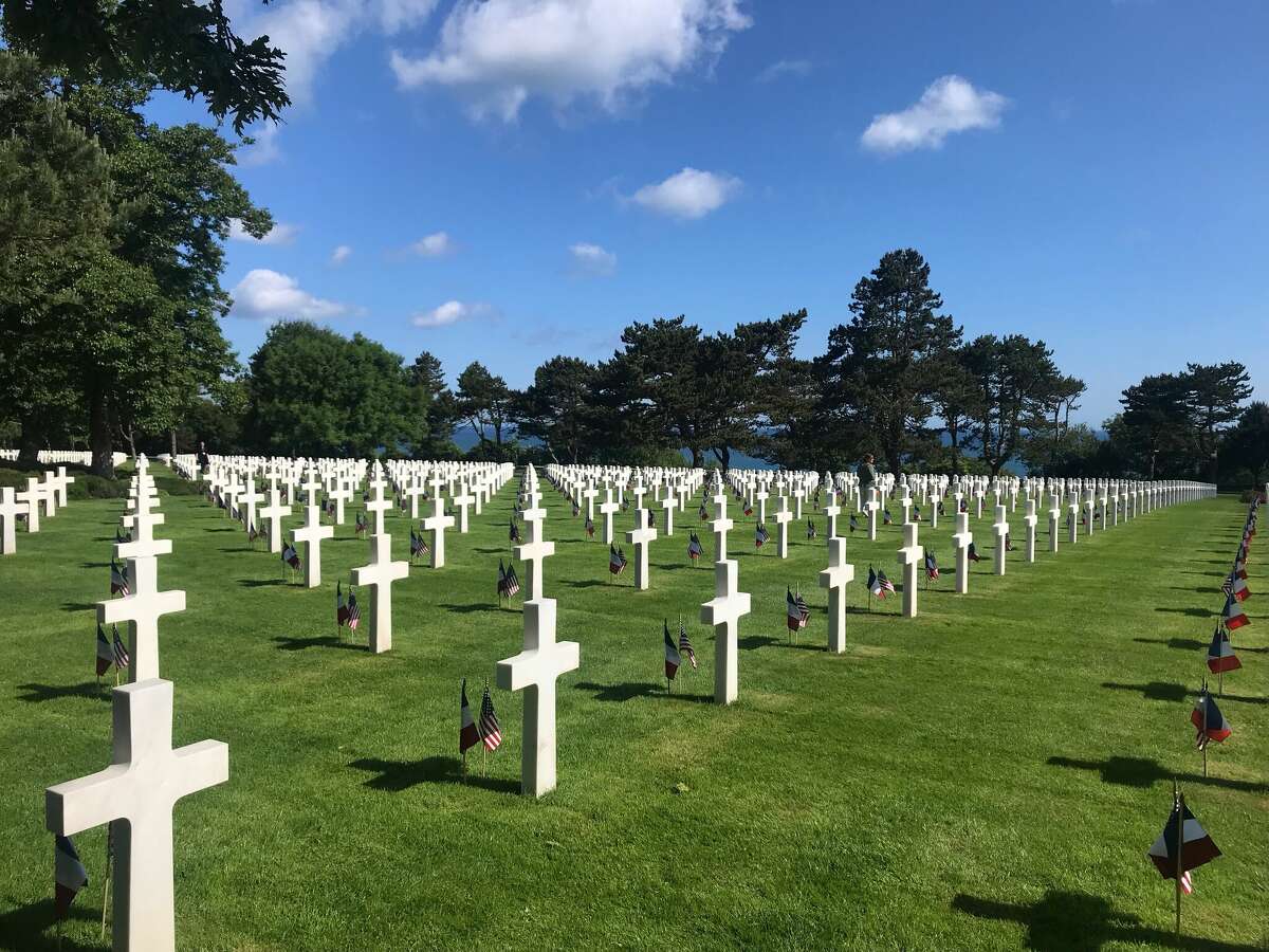 Crosses mark the graves of World War II American soldiers at the Colleville-sur-Mer American Cemetery at Omaha Beach, France. Volunteers place a U.S. flag and a French flag at all 10,000 crosses at the cemetery by June 9, the day that Trevieres was liberated. All the crosses face the water, toward the United States. The crosses were given by the French to America so its soldiers could be buried there with honor.