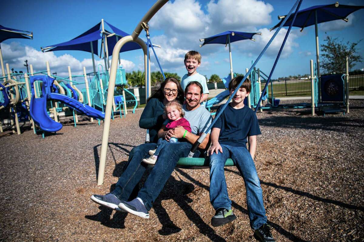 Ryan Labbe, 42, and Dr. Trine Engebretsen, 41, play with their three children Andersen, 11, Owen, 7, and 1-year-old Liv during a photo session on Saturday, December 3, 2022 in Texas City, Texas. When she was two, Dr. Engebretsen became Florida's first liver transplant recipient. She supported Labbe through a liver transplant when he was 27 years old. They are the first liver recipient couple to have children. “Our entire family would not exist if it weren’t for the generosity of an organ donor,” said Dr. Engebretsen.