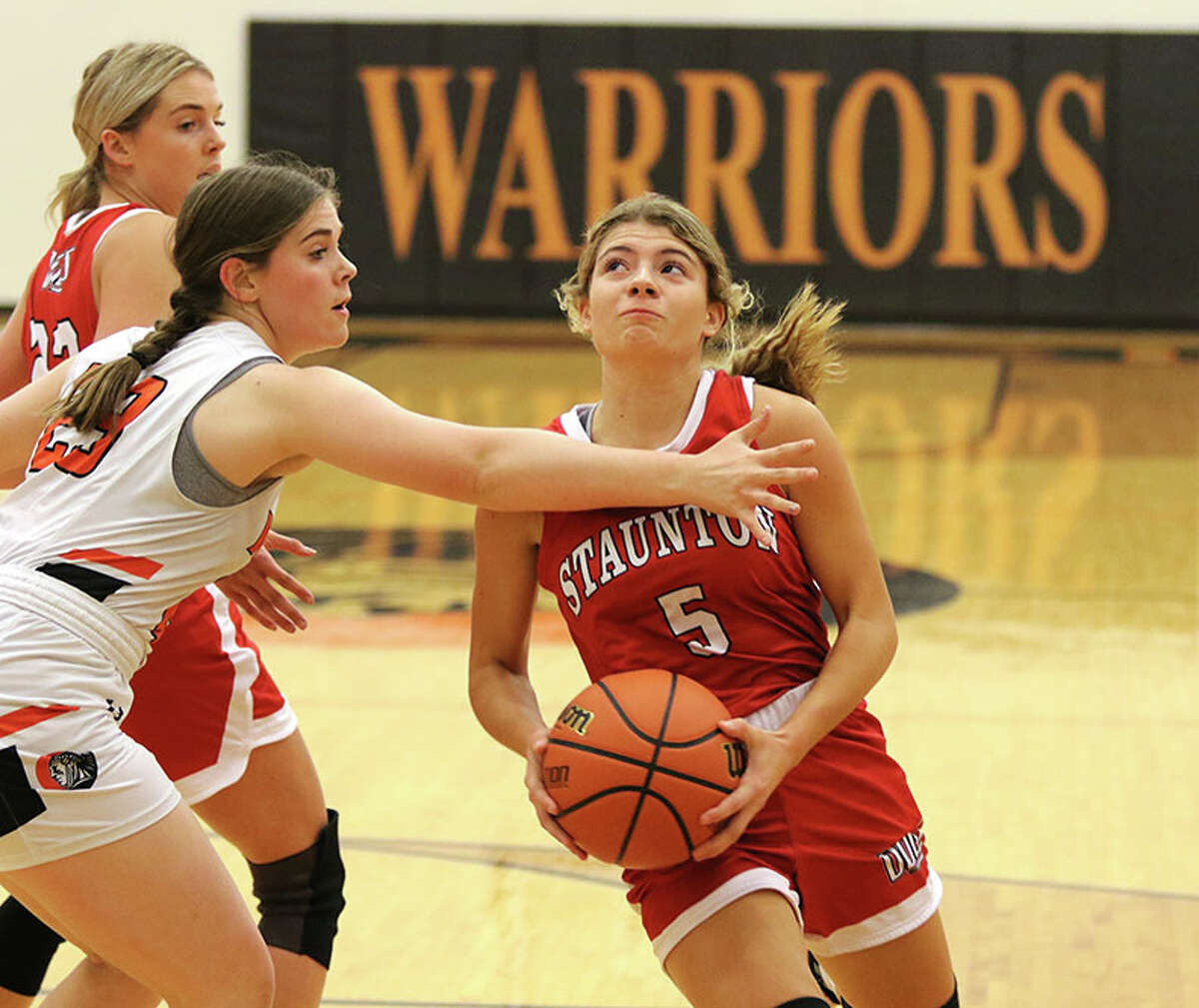 Staunton's Lilly Bandy (right) goes to the basket in a November game against Wesclin at Trenton. On Monday, Bandy scored 20 points in the Bulldogs' SCC win over Vandalia.