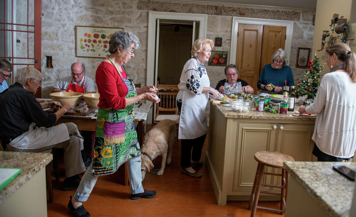 Herring salad is a tedious dish to make. It took nine adults two full hours to prepare, including, from left, Arthur Uhl, Fred Pfeiffer, Bubba Groos, Maria Pfeiffer, Janet Casey, Nancy Turner, Carol Gross and Lisa Uhl.