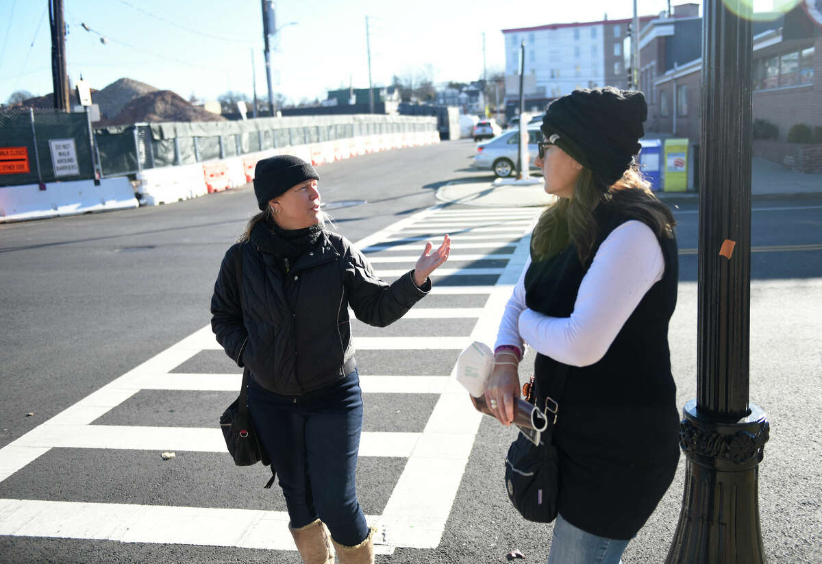 Kikki Short, left, and Monica Fonseca, of the Port Chester Main Street Association, walk along North Main Street in downtown Port Chester, N.Y. Tuesday, Dec. 13, 2022. Port Chester has seen a growing number of high rise apartments being approved and developed in the downtown area lately and many residents say that the town is developing too much too quickly.