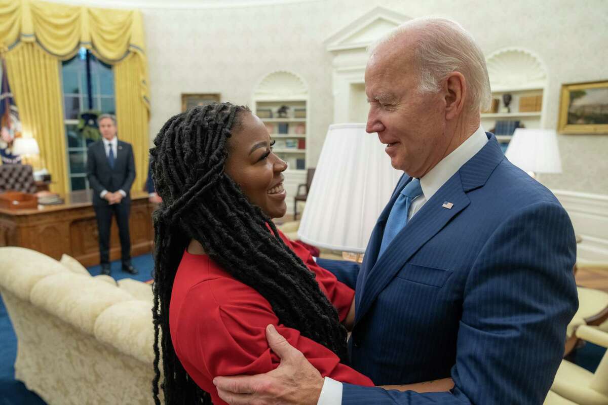 WASHINGTON, DC - DECEMBER 8: In this handout released by The White House, President Joe Biden meets Cherelle Griner about the release of Brittney Griner in the Oval Office of the White House on December 8, 2022 in Washington, DC..Olympian and WNBA player Brittney Griner was released as part of a prisoner swap that involved Russian arms dealer Viktor Bout.