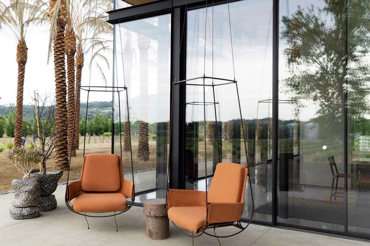 Swinging chairs sit outside large glass windows of the tasting room at Caymus-Suisun Winery in Solano County’s Suisun Valley. It’s the valley’s largest winery and marks a major milestone for this low-profile wine region that's long been in Napa’s shadow.
