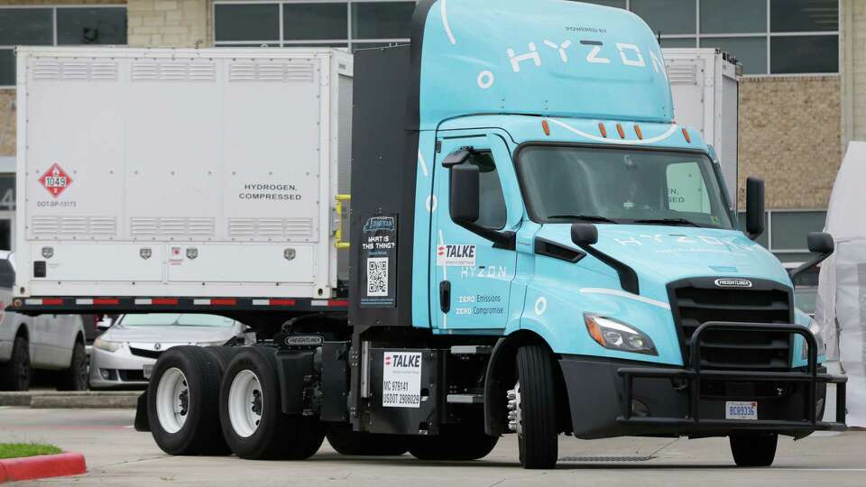 A Freightliner semi-truck, converted to run on hydrogen, passes in front of the portable fuel trailer during the 