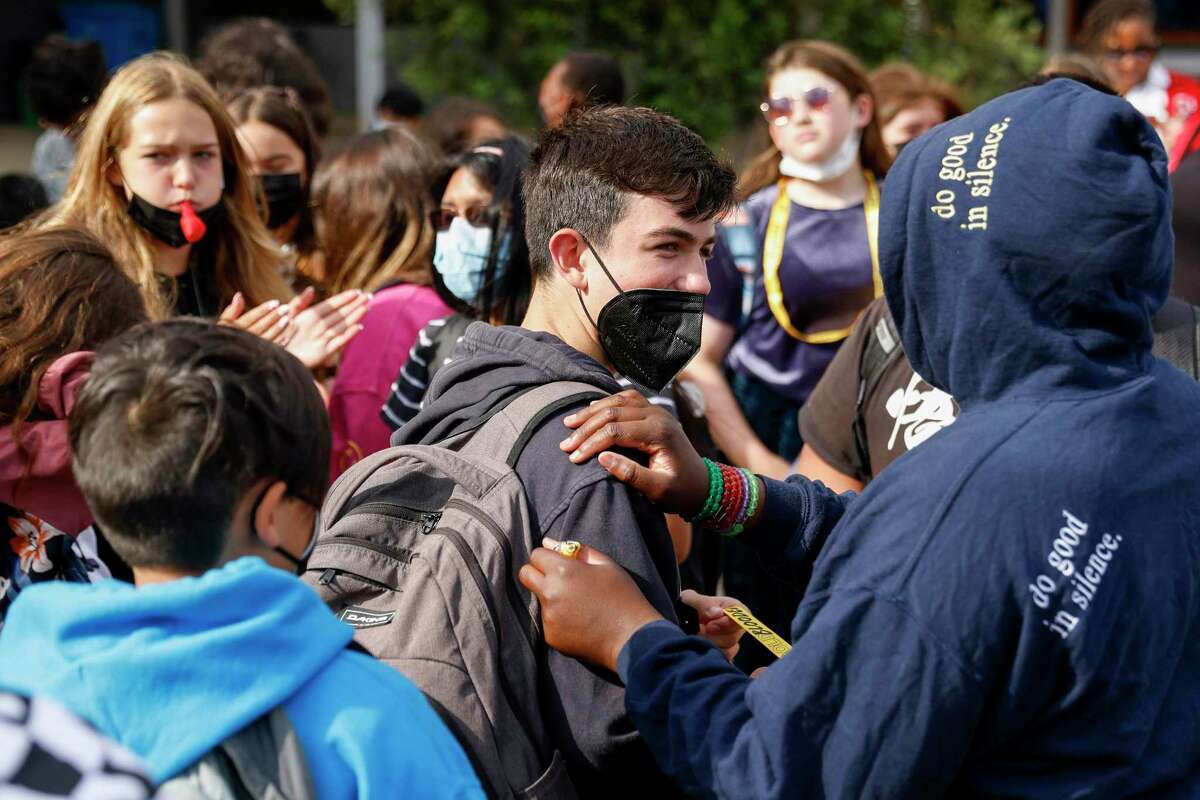 COVID, flu and RSV are causing Bay Area students to miss school. Students are seen masked and unmasked as they listen to announcements from their principal on the first day of school at Willie Brown Jr. Middle School in San Francisco, Calif. Wednesday, Aug. 17, 2022.