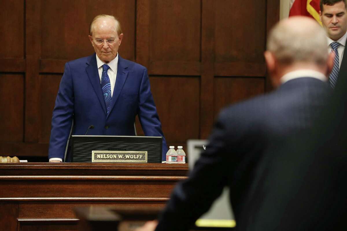 Bexar County Judge Nelson Wolff bows his head during the opening prayer at his last commissioners court meeting, Tuesday, Dec. 13, 2022. Wolff, 82, did seek reelection for the position he’s held for 21 years.