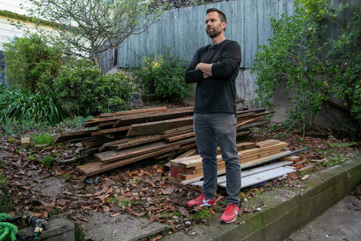Scott Pluta stands in the side yard of his 17th Street home in San Francisco, where he plans to build a six-story “builder’s remedy” project with a mix of affordable and market-rate housing.