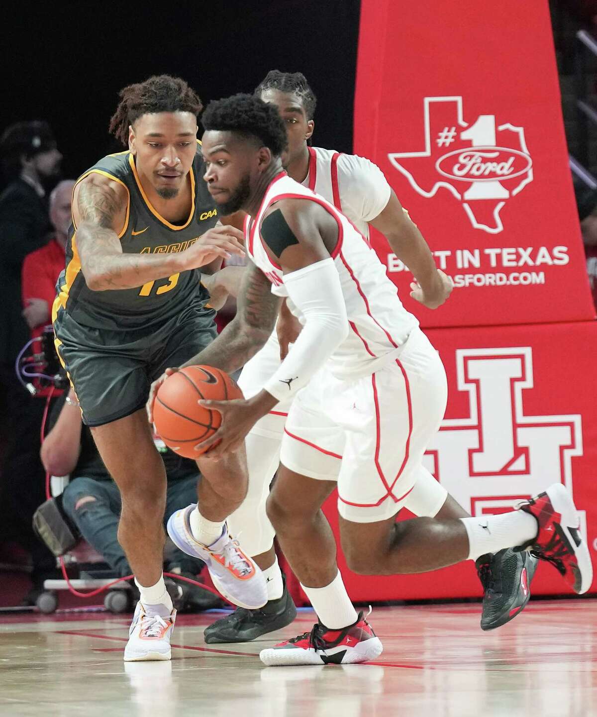 Houston Cougars guard Marcus Sasser (0) steals the ball from North Carolina A&T Aggies guard Austin Johnson (13) in the second half at the Fertitta Center on Tuesday, Dec. 13, 2022 in Houston. Houston Cougars won the game 74-46.