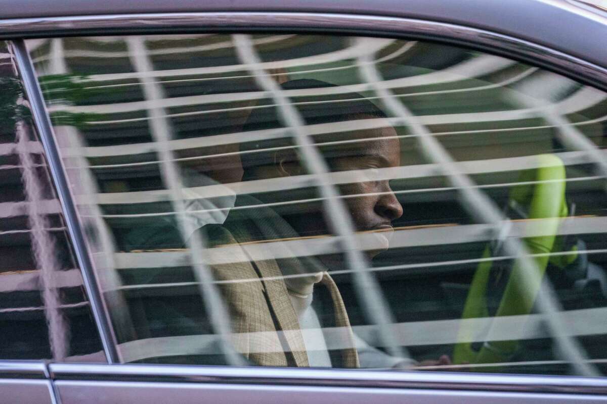 Daystar Peterson, the rap artist known as Tory Lanez, 30, sits in the passenger seat of a sport car as he's driven away from the Clara Shortridge Foltz Criminal Justice Center Tuesday, Dec. 13, 2022, in Los Angeles. Lanez is free on bail after being charged with felony assault for allegedly shooting rapper Megan Thee Stallion in the feet.