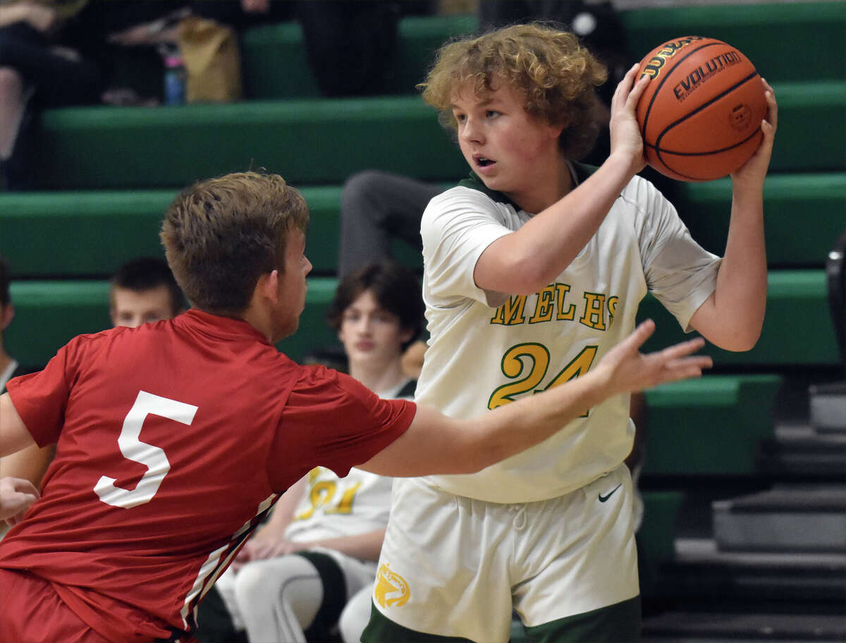 Metro-East Lutheran's Ian Skelton shields the ball from Bunker Hill's Grant Burch in the second half on Tuesday in Gateway Metro Conference action in Edwardsville.