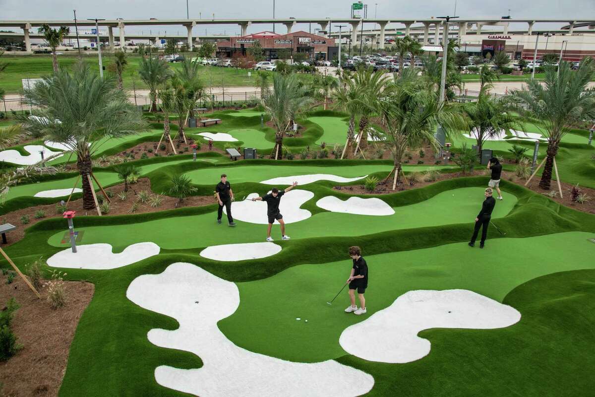 Staff prepares for the soon to be opening putt-putt golf course by Tiger Woods on Tuesday, Dec. 13, 2022, at Pop Stroke in Katy.
