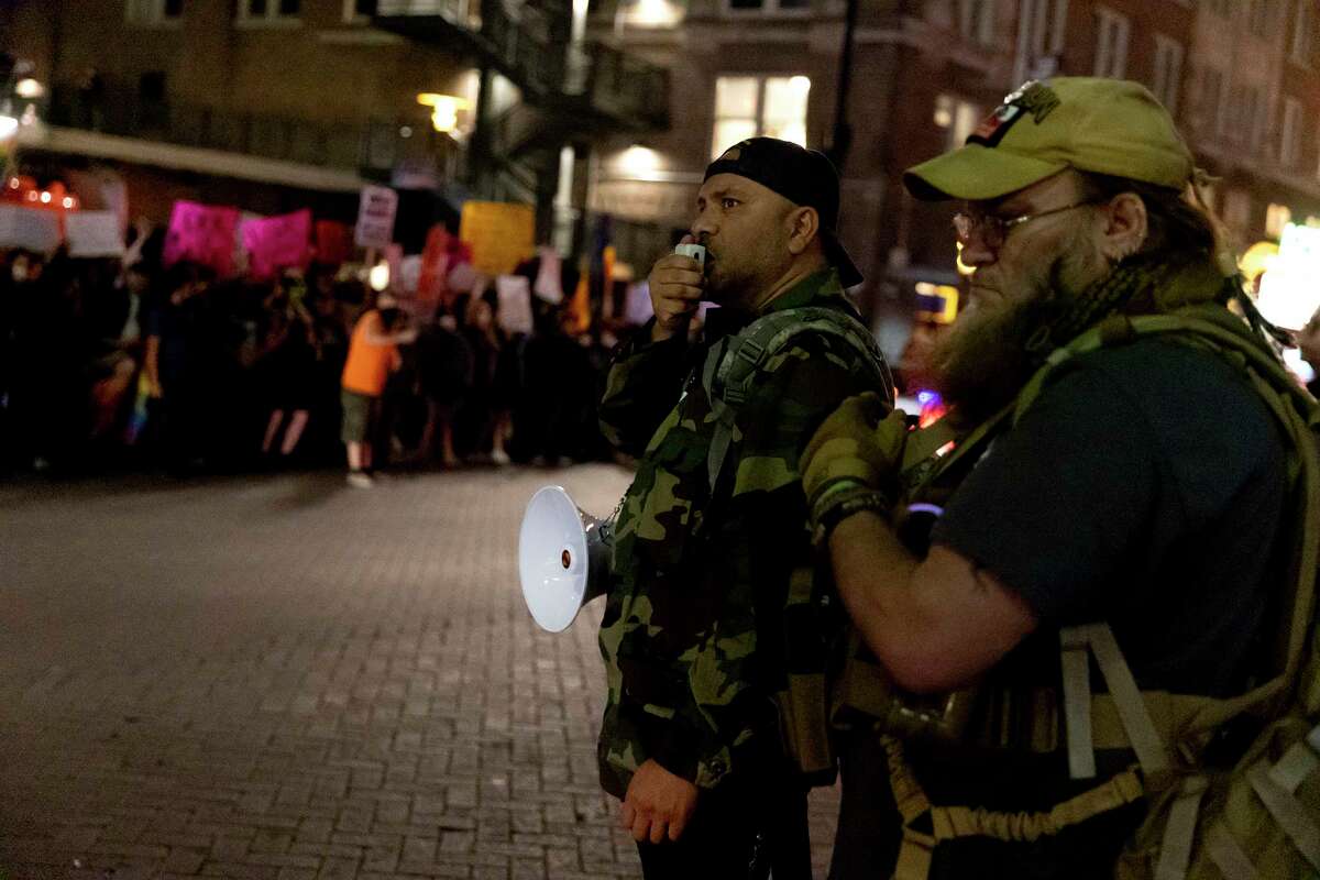 Members of the group This Is Texas Freedom Force, a group described as an “extremist militia” by the FBI protest the drag show, “A Drag Queen Christmas,” at the Aztec Theater Tuesday night, as Texas reported the most such incidents of protests at drag events.