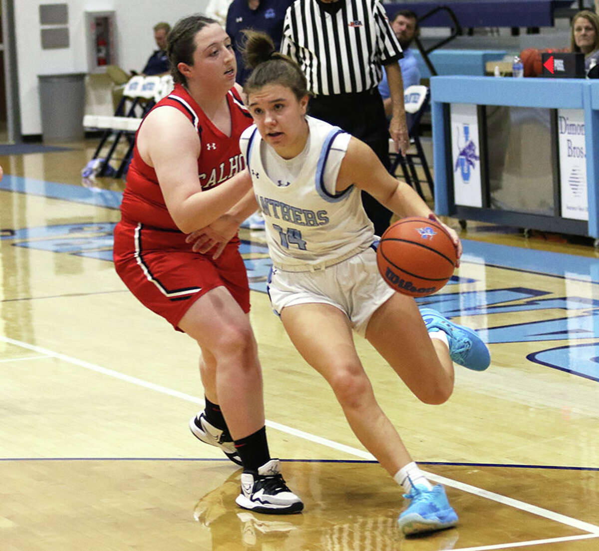 Jersey's Cate Breden (right) drives past Calhoun's Anna Oswald in a game earlier this month in Jerseyville. On Tuesday, the Panthers opened play at the Orchard Farm Tournament in Missouri with a victory.