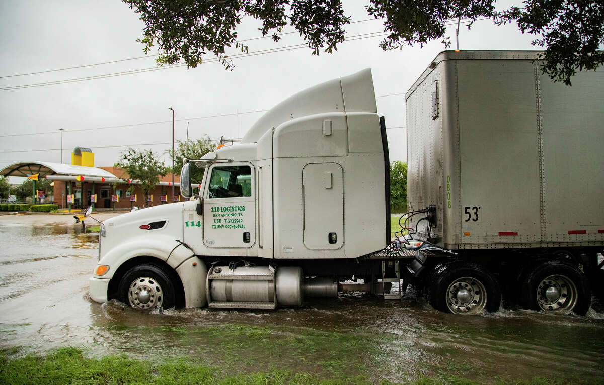 A semi-tractor-trailer rig drives through water from Tropical Storm Beta in 2020 in Pearland. City Council is considering drainage projects for inclusion in a possible May bond election. The package could also include projects for new facilities and improvements to roads and parks. 