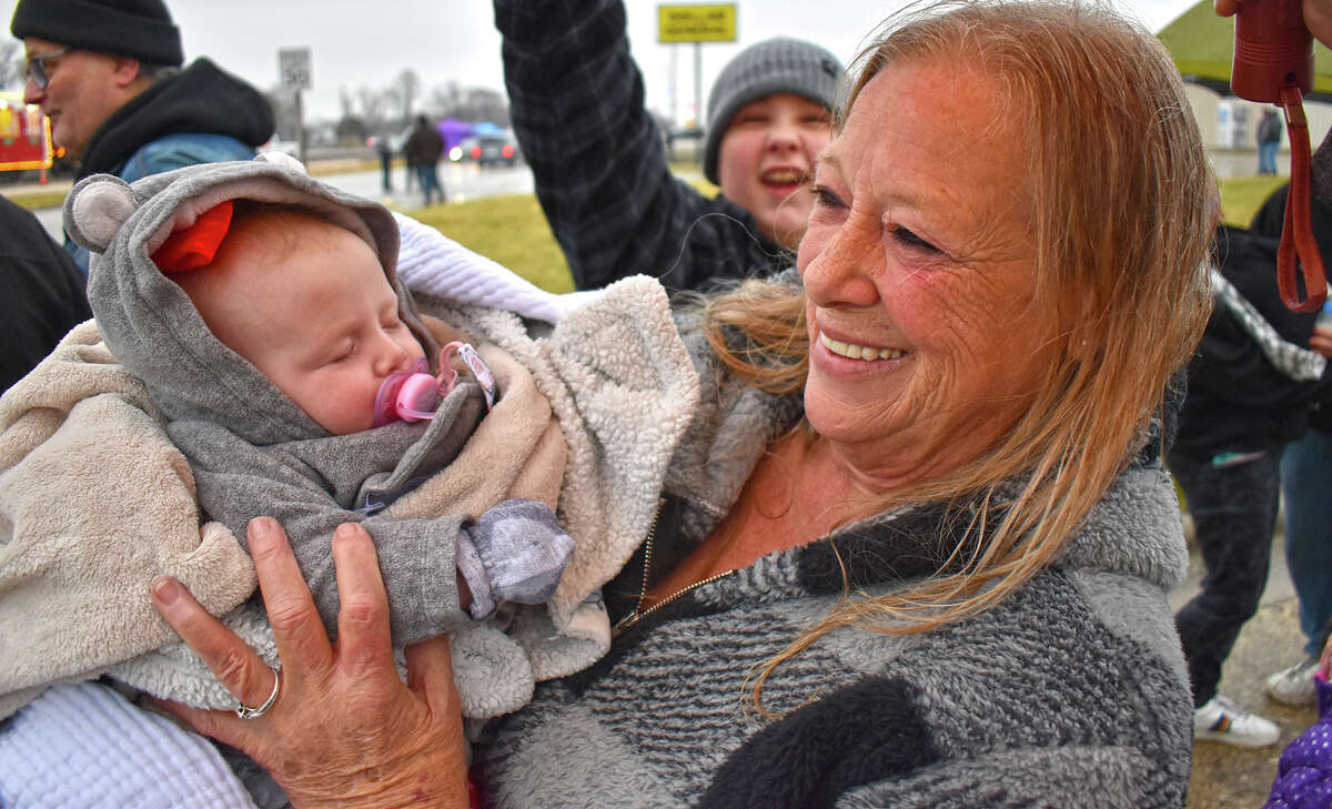 Cindy Scott of White Hall holds her granddaughter, Oakleigh Lynn Spradlin, while standing in line for the Kansas City Southern Holiday Express train in Roodhouse. Scott, who has attended every Holiday Express visit to the region, is continuing the family tradition with Oakleigh.