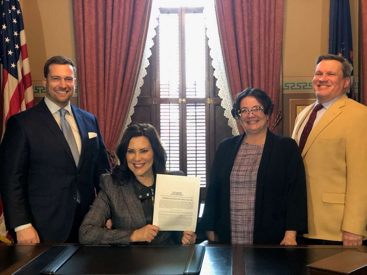 Michigan Gov. Gretchen Whitmer on Dec. 13 in Traverse City signed a legislation package designed to boost attainable housing development across Michigan. She was joined by officials from northern Michigan.