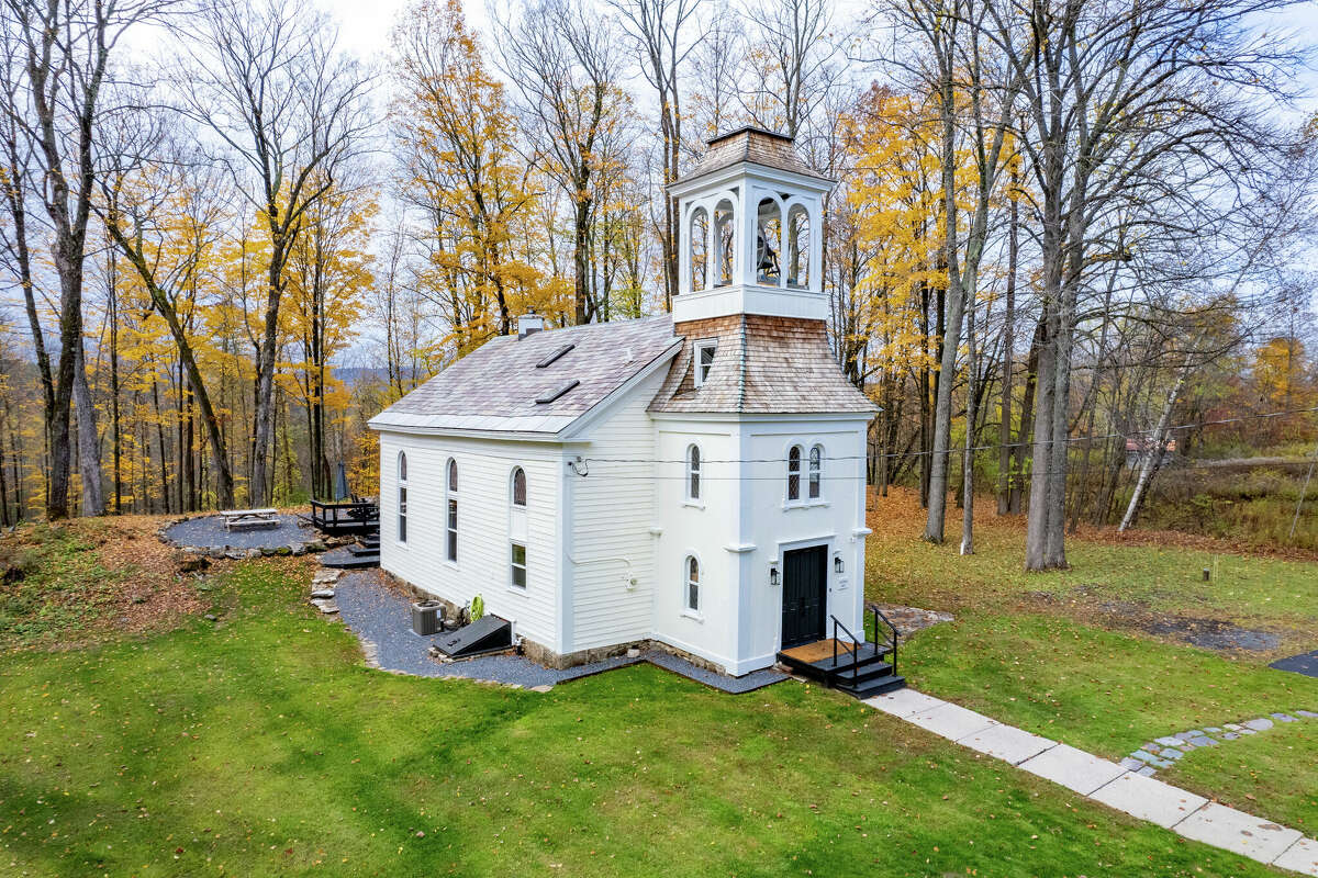 Without seeing the photos with this listing, it would sound fairly typical: A three-bedroom, one-and-a-half bathroom home under 2,000 square feet, on just under an acre of land. But when you see how that square footage is contained, maybe your jaw does what mind did, and drops a little.  The North Church was built in 1867 and has been updated to serve modern life. There are original touches that play up the church’s charm, like wood beams framing the 30-foot ceilings, the bell hanging from the tower and beautiful stained glass windows throughout the house. The majority of the house has newer features, from the deck and outdoor fireplace to the modern kitchen and bathrooms. It comes fully furnished, so turnkey is the keyword. New HVAC and septic systems. Taxes: $2,500. Listing price: $795,000. For more information, contact Erin Sipowicz, of the Erin Sipowicz Team of Howard Hanna Real Estate, at 518-307-6348 or erinsipowicz@howardhanna.com.