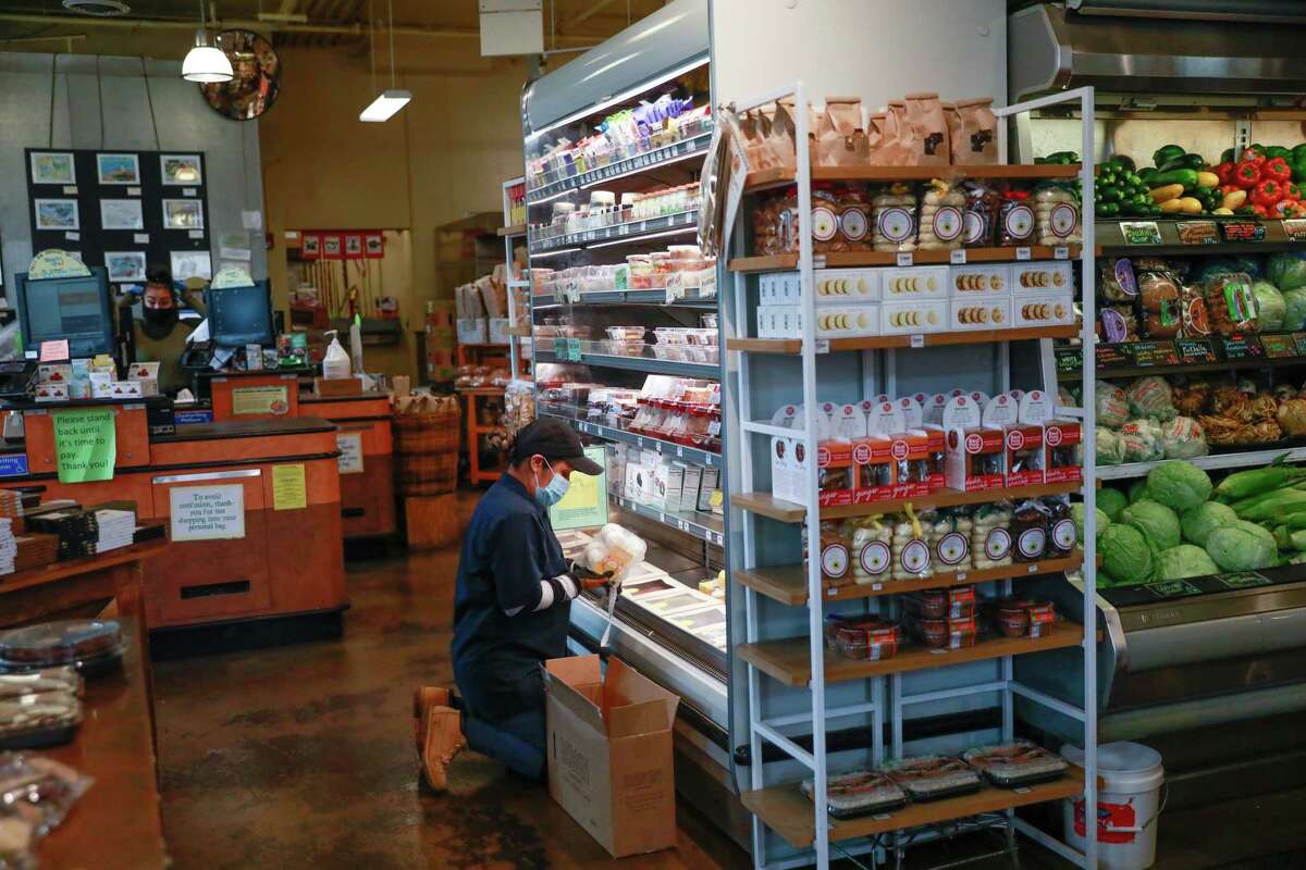 Marbella Garcia stocks inventory at Canyon Market in San Francisco.