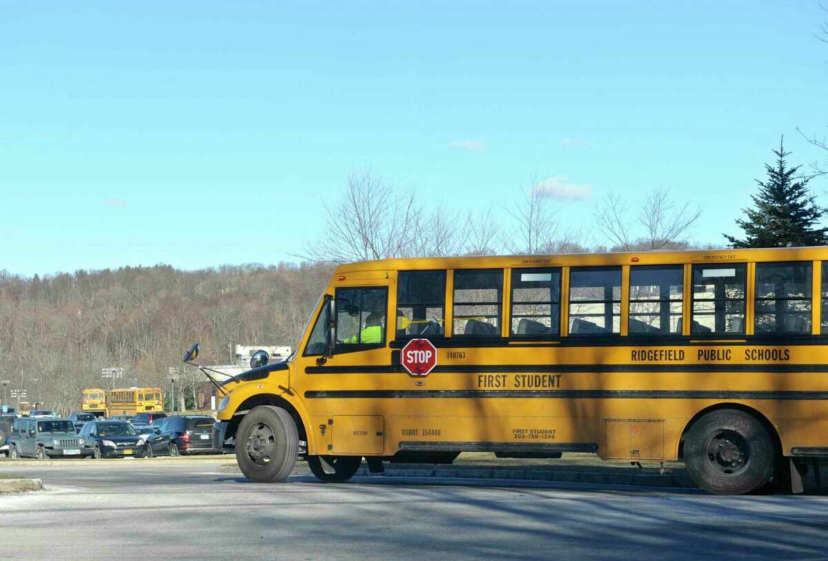 A school bus heads towards Ridgefield High School on Thursday afternoon at the end of the school day.