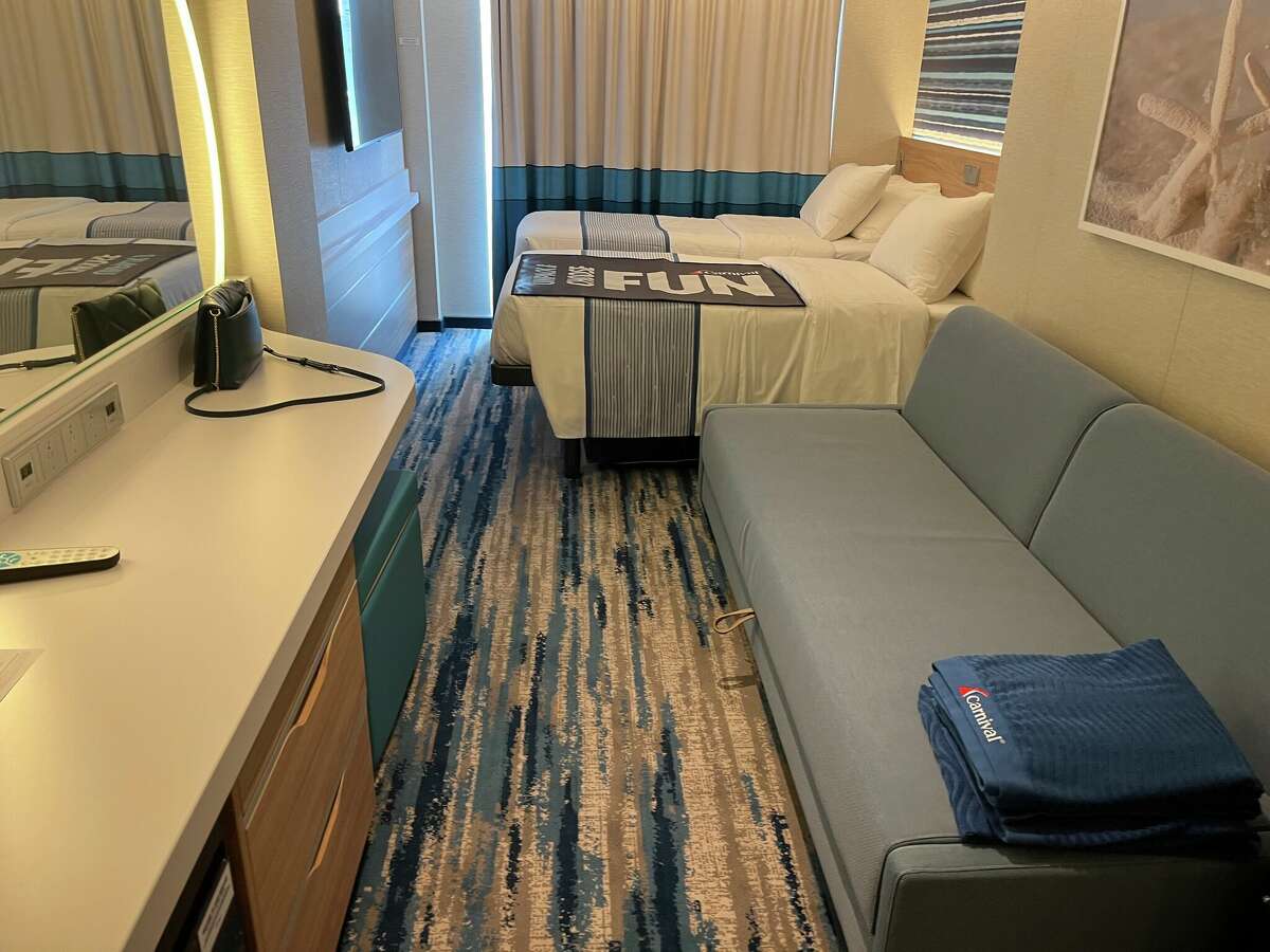 A stateroom on the Carnival Celebration cruise ship. The two single beds can either be separated or combined into a queen, and the couch also pulls out into a bed.