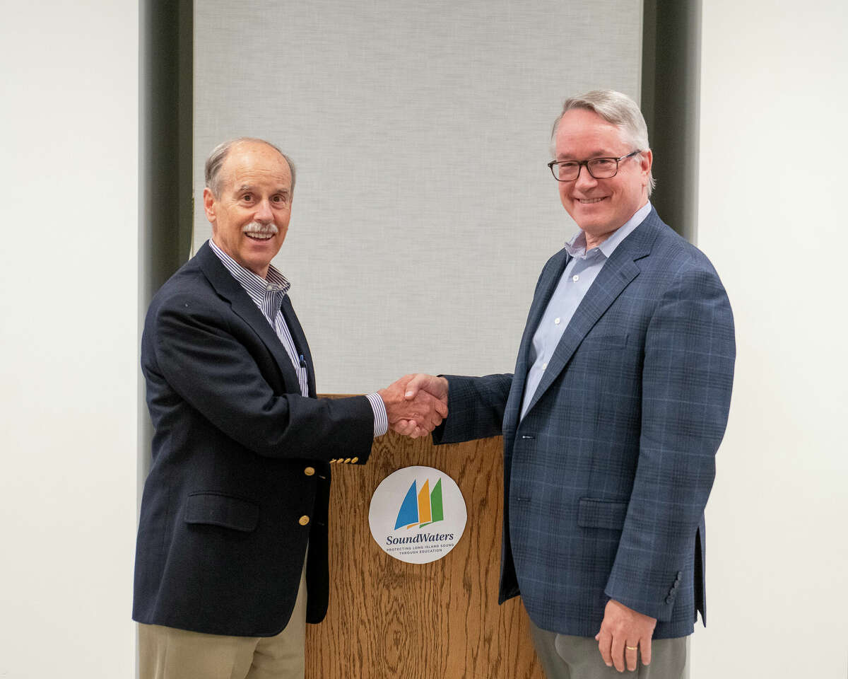 Outgoing Board Chair, Doug Bora of Darien (left) congratulates Tony Allott of Westport on his election as the board chair. The Connecticut Conference of Municipalities is asking local officials to commit to a civility pledge to help combat unruly behavior at public meetings. 