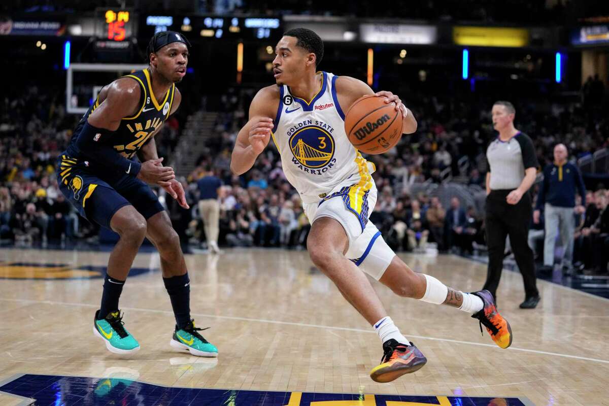Golden State Warriors guard Jordan Poole (3) drives on Indiana Pacers guard Buddy Hield (24) during the first half of an NBA basketball game in Indianapolis, Wednesday, Dec. 14, 2022. (AP Photo/Michael Conroy)
