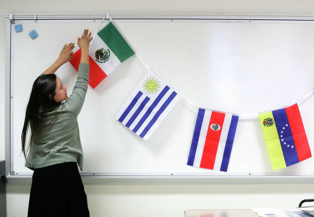 AP Spanish teacher Rosie Roque hangs flags as she prepares her classroom at Chavez High School, Thursday, Aug. 11, 2022, in Houston. The Houston Independent School District, the stateâs largest system, starts school on Aug. 22, despite a shortage of educators that have left districts across the Houston region scrambling to fill thousands of teacher vacancies.