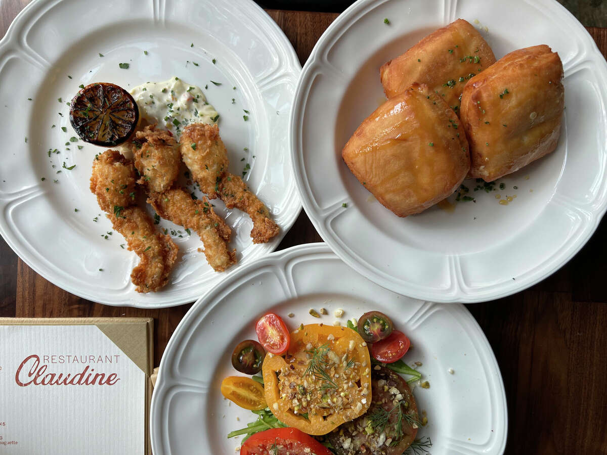 The menu includes fried frog legs, blue crab beignets and an heirloom tomato salad at Restaurant Claudine in Government Hill in San Antonio. 