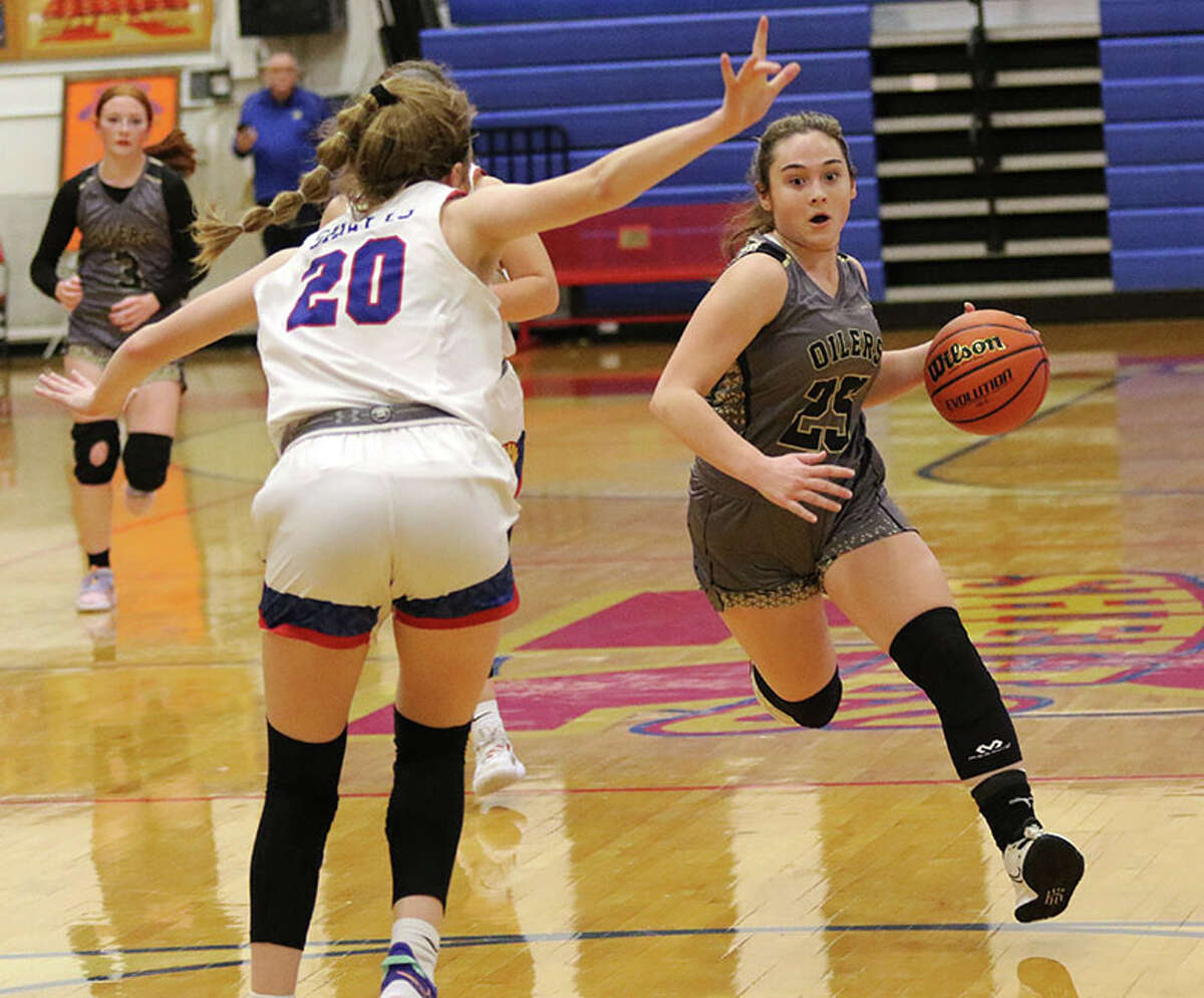 EA-WR's Milla LeGette takes the ball to the basket against Roxana's Laynie Gehrs (15) in a Cahokia Conference girls basketball game Wednesday night in Roxana.