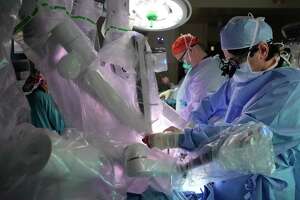 As Houston heart surgeons tap robot assistance, questions remain