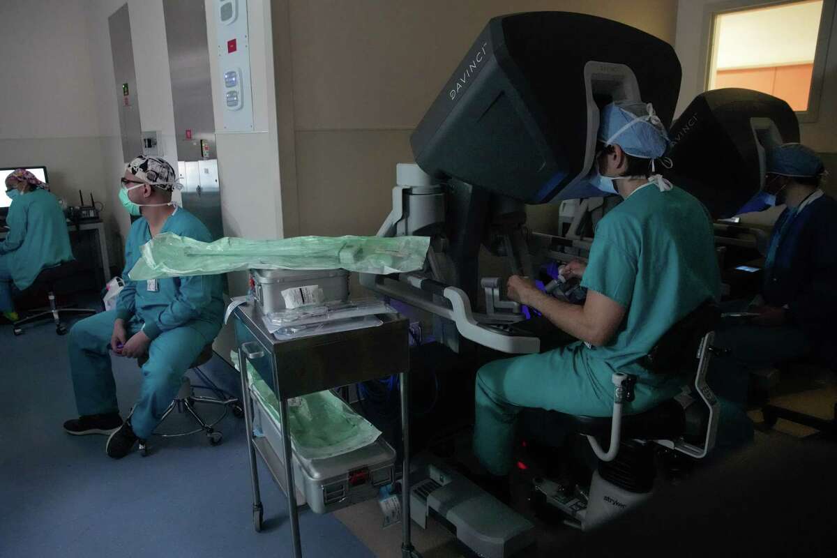 Dr. Danny Ramzy operates robotic arms to perform an aortic valve replacement surgery from a console Wednesday, Dec. 14, 2022, at Memorial Hermann Memorial City Medical Center in Houston.