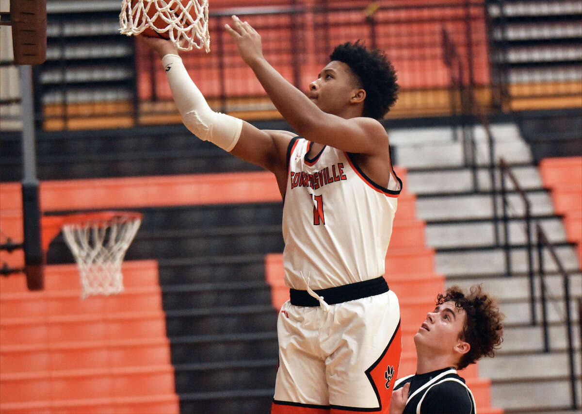 Edwardsville's Kris Crosby lays in a basket against Metro during the second half on Wednesday inside Lucco-Jackson Gymnasium in Edwardsville.