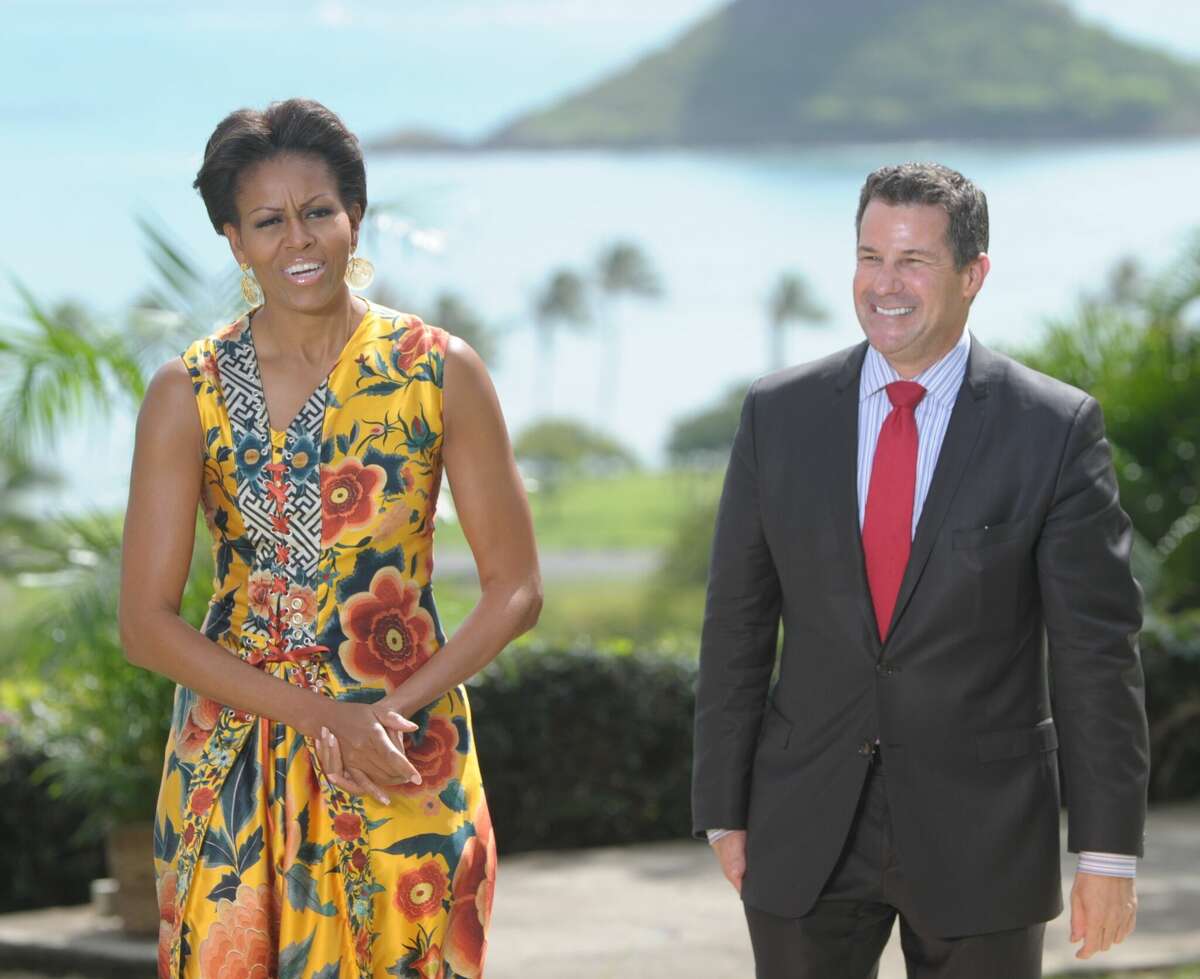 US First Lady Michelle Obama (L) stands with new White House social secretary, Jeremy Bernard (R), as she hosts the Asia-Pacific Economic Cooperation (APEC) leaders' spouses luncheon at Kualoa Ranch in Ka'a'awa on the island of Oahu in Hawaii on November 13, 2011. The 4,000 acre working cattle ranch, established in 1850, overlooks the Paliku mountains and the Kualoa beach front. AFP PHOTO / Saul LOEB (Photo credit should read SAUL LOEB/AFP via Getty Images)