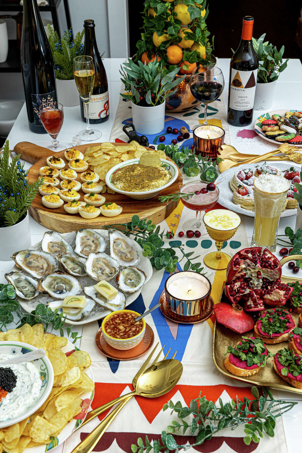 A table spread for a holiday party was put together by Times Union dining critic Susie Davidson Powell, inspired by dishes and cocktails she had a Capital Region restaurants in 2022.