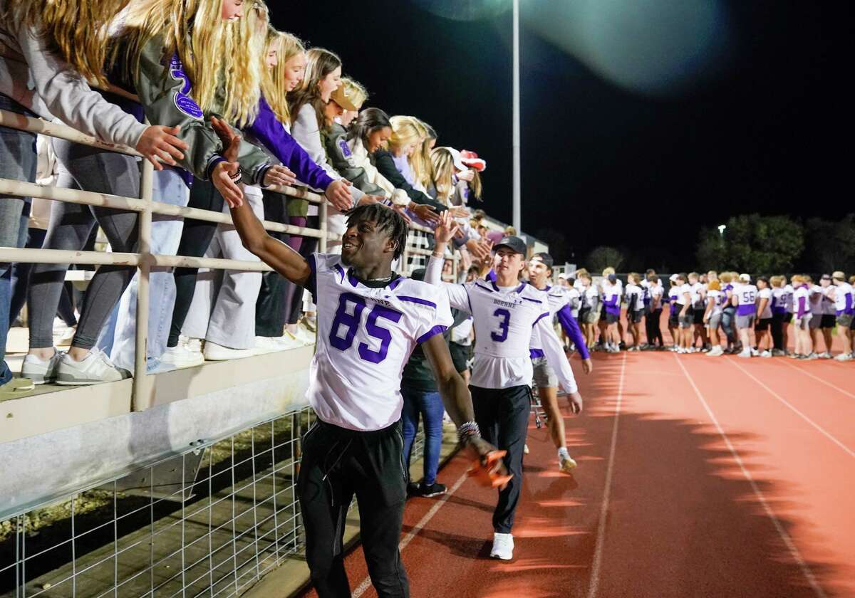 Boerne High School’s Michael Igbo high-fives fans during a pep rally for the undefeated football team Wednesday evening at Boerne ISD Stadium. The Greyhounds head to Arlington on Friday to play for the Class 4A Division 1 state championship.