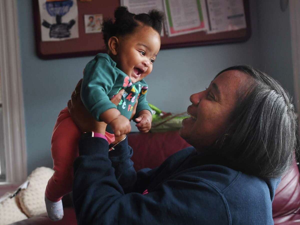 Lil' Sunshine Home Day Care owner Kamara Moodie interacts with little Leah Roberts, 6 months, in the baby room at her business at 45 Butler Avenue in Bridgeport, Conn. on Thursday, December 15, 2022.
