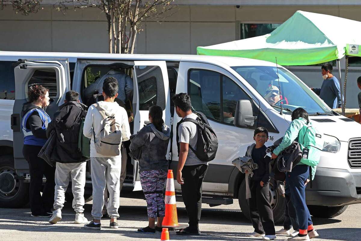 Migrants board a van outside the Migrant Resource Center on San Pedro Avenue, Thursday, Dec. 15, 2022. The city of San Antonio is seeking federal funds to keep the center operating through March.