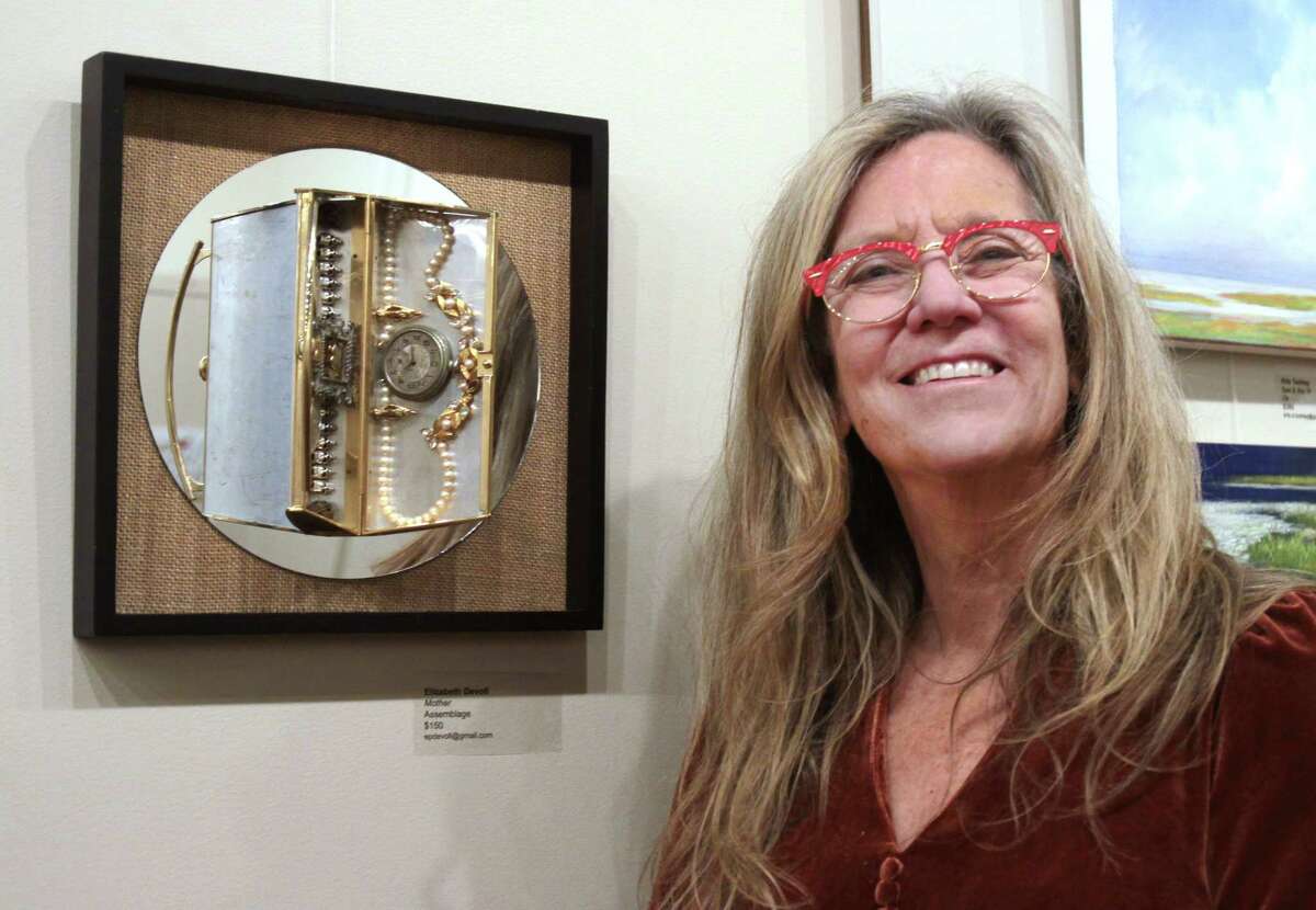 Local artist Elizabeth DeVoll, poses with her artwork which is on display at The Gallery at the Westport Country Playhouse as part of the Artists Collective of Westport's Small Works Holiday show in Westport, Conn., on Thursday December 15, 2022.
