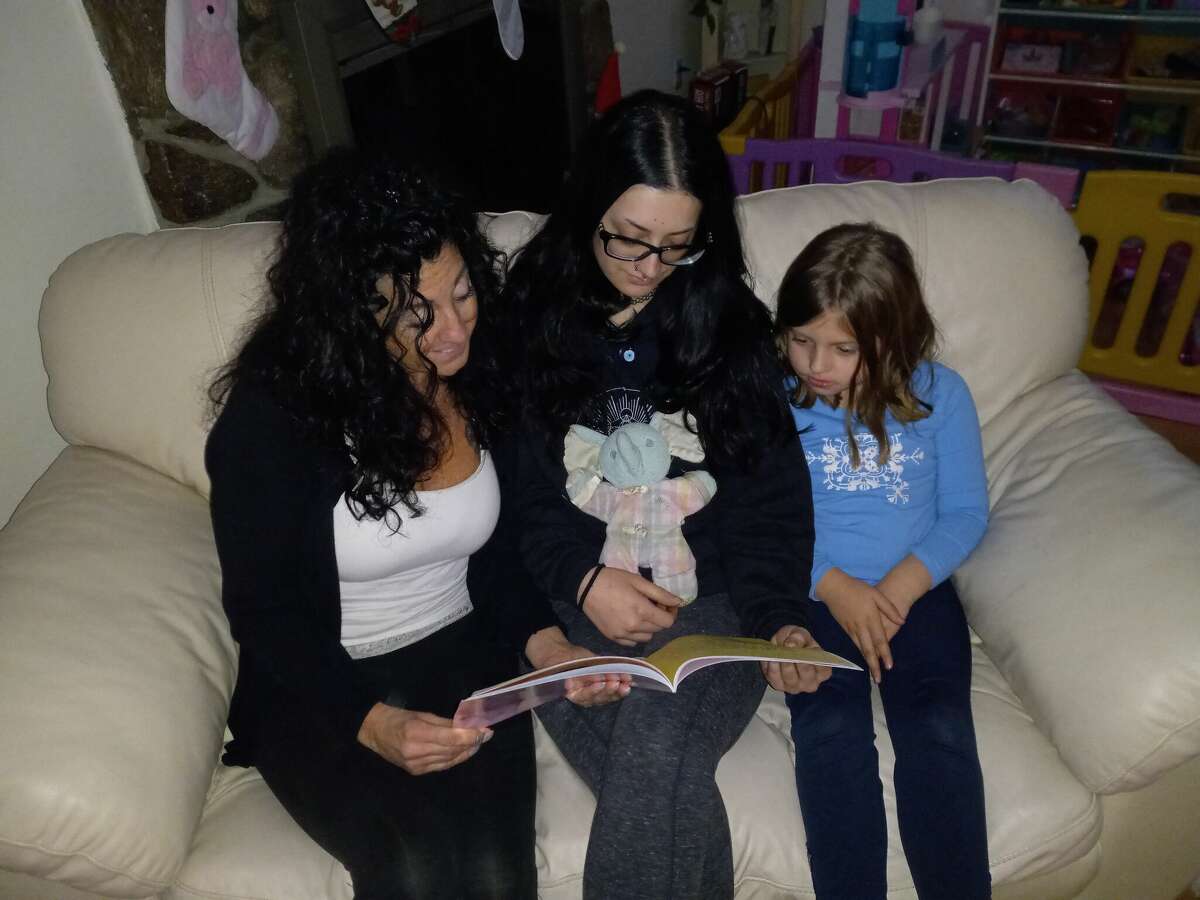 Elizabeth Allyn Morro's book, "Ellie, Ellie, Where'd You Go?," is based on an actual experience with her daughter, Heather Desmond, center, holding her own Ellie, a toy elephant. Also pictured is Desmond's daughter, Rachel Broadbent, 6. The illustrations are by Ros Webb.