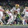 San Francisco 49ers quarterback Brock Purdy (13) rolls out against the Seattle Seahawks in an NFL football game, Thursday, Dec. 15, 2022, in Seattle Wash. (AP Photo/Jeff Lewis)