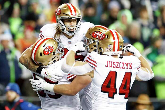 San Francisco 49ers quarterback Brock Purdy runs against Seattle Seahawks  defensive tackle Quinton Jefferson during the second half of an NFL  football game in Seattle, Thursday, Dec. 15, 2022. (AP Photo/Marcio Jose