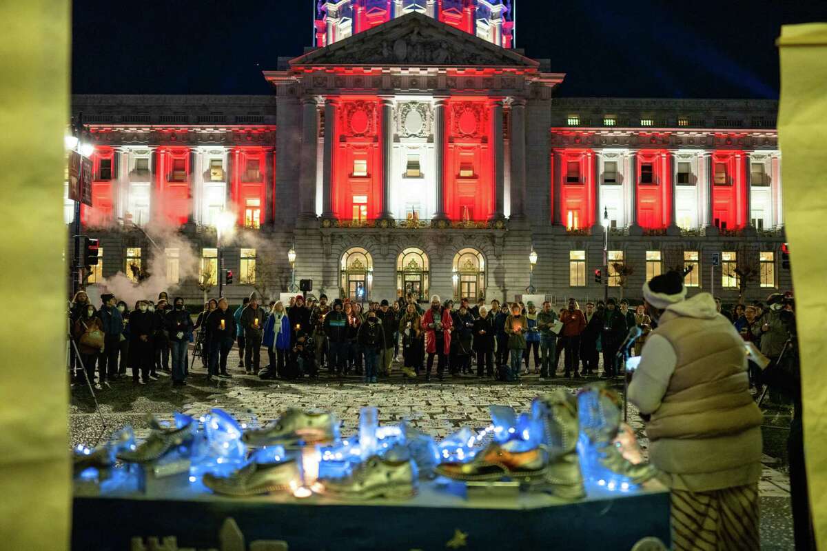 People in attendence of the Vigil: Annual Homless Persons Memorial hold candles and listen to the names of those who have died in the past year outside of City Hall in San Francisco, Calif. on Thursday, Dec. 15, 2022.