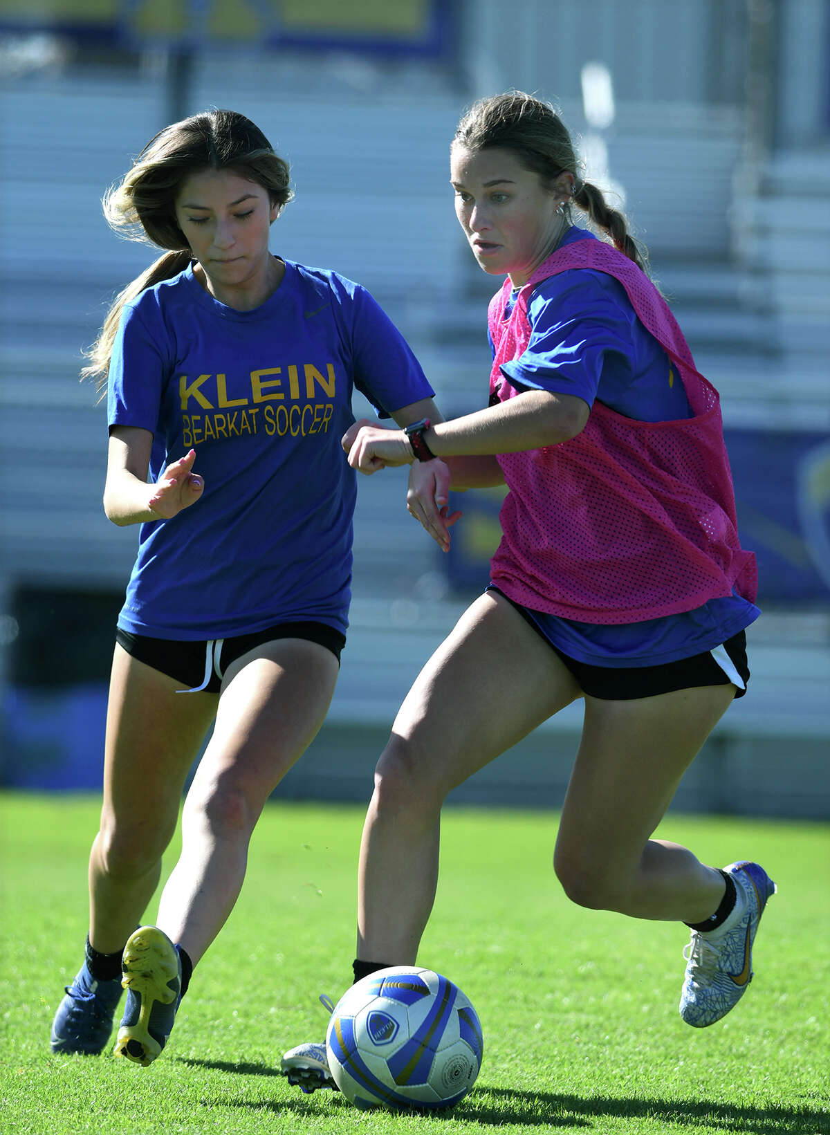 Klein High School senior Maddie Nissen, right, works the ball upfield against a teammate during a varsity team soccer practice on Dec. 15, 2022.