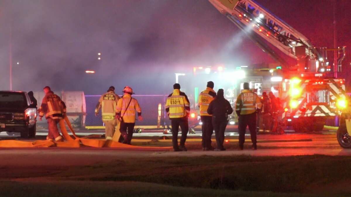 Firefighters battle a fire at David Wayne Hooks Memorial Airport, near Tomball, early Friday. 
