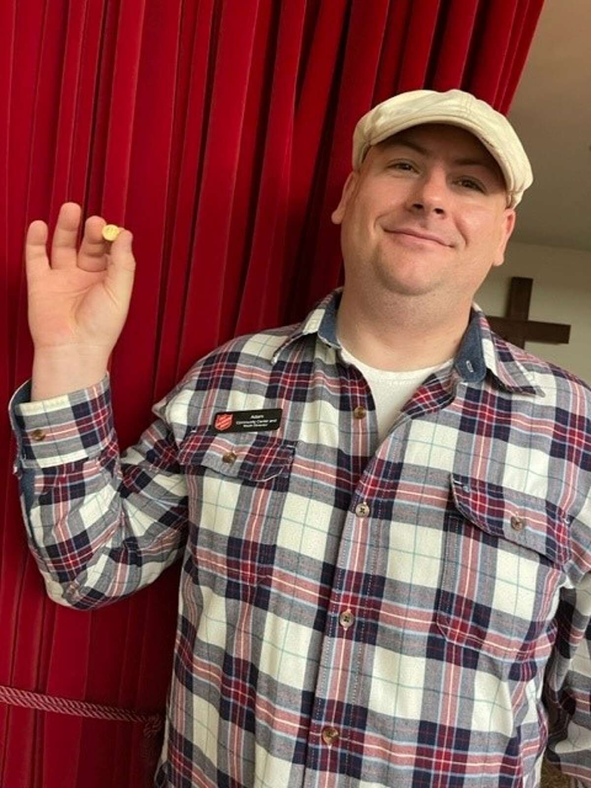 Adam Thiel, the Community Center and Youth Director for the Madison County Salvation Army Corp., shows off a donated gold coin.